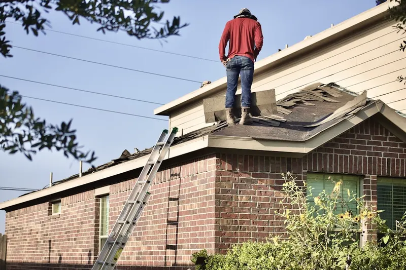 Professional roofer working on a residential roof in High Street Neighborhood